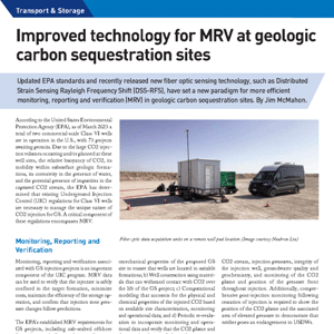 A trailer, equipment container, and van are set up on a flat, dry landscape beside carbon sequestration monitoring devices and a fiber optic cable spool.