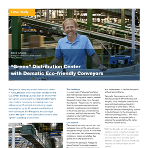 A man stands smiling in front of green conveyor systems in a warehouse, featured in a case study about eco-friendly distribution centers.