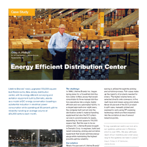 A man stands in a warehouse surrounded by stacked pallet boxes. The background shows shelves with more boxes and equipment. Text on the image discusses energy-efficient distribution centers.