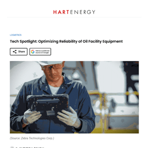 A worker in safety gear inspects a handheld electronic device at an industrial oil facility.